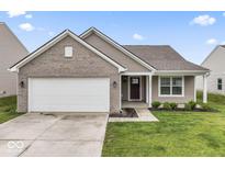 Charming single-story home featuring a two-car garage and a well-manicured lawn at 10107 Camp Creek Way, Indianapolis, IN 46229