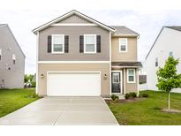 Charming two-story home featuring a two-car garage and a well-maintained front yard at 10210 Samerton Ln, Indianapolis, IN 46239