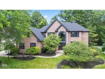 Beautiful brick home with a well-manicured lawn and mature trees offering shade at 11266 Old Stone Dr, Indianapolis, IN 46236