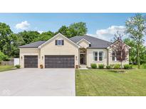 Charming, light brick home with a well-manicured lawn and an attached two-car garage at 14729 Erica Ln, Carmel, IN 46033