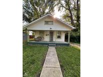 Charming bungalow featuring a covered porch, green trim, and inviting curb appeal at 1728 N Somerset Ave, Indianapolis, IN 46222