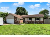 Charming single-story home with a brick and vinyl exterior, well-maintained lawn, and attached two-car garage at 1759 Michele Ln, Greenwood, IN 46142