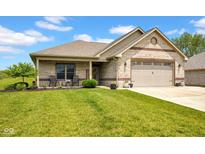 Attractive brick home featuring a cozy front porch with seating and a lush green lawn at 3072 W Glacier Dr, Monrovia, IN 46157