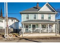 Charming two-story home with a covered front porch and a well-maintained yard at 48 E Palmer St, Indianapolis, IN 46225