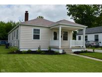 Charming single-story home with a front porch, manicured lawn, and fresh landscaping at 5430 E 17Th St, Indianapolis, IN 46218