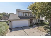 Charming two-story home with a two car garage, neutral siding and attractive landscaping at 6214 Weller Cir, Indianapolis, IN 46268