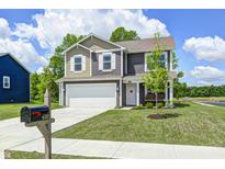 Charming two-story home with a well-manicured lawn, attached garage, and inviting curb appeal at 6332 Card Blvd, Indianapolis, IN 46221