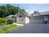 Charming home featuring stone and siding, with an attached two-car garage and a well-maintained driveway at 6586 Quail Run, Fishers, IN 46038