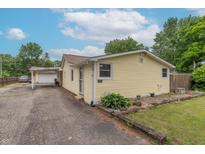 Charming single-story home with a well-maintained yard, a covered carport, and classic curb appeal at 6805 Jackson St, Indianapolis, IN 46241