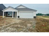 Charming single-story home with a two-car garage, white siding, and dark brown brick accents at 6812 Rawlings Ln, Indianapolis, IN 46221