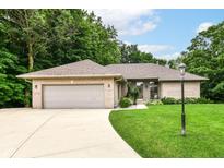 Charming brick ranch home with a well-manicured lawn and attached two-car garage at 7175 Scarlet Oak Dr, Noblesville, IN 46062