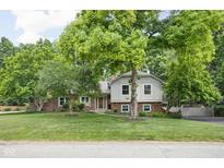 Charming two-story home with landscaped yard and mature trees at 7629 Candlewood Ln, Indianapolis, IN 46250