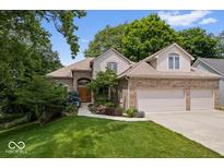 Charming brick home with a well-manicured lawn and lush landscaping at 817 Hickory Way, Noblesville, IN 46062