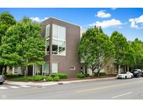 Modern brick condo building featuring a landscaped yard and ample natural light from its many windows at 932 N Broadway St # 4, Indianapolis, IN 46202