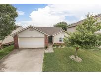 Charming home featuring a manicured front yard with a lush green lawn and mature tree at 11117 Waterfield Pl, Indianapolis, IN 46235