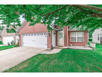 Charming brick home with a two-car garage, a well-manicured lawn, and a cozy front entrance at 11222 Boston Way, Fishers, IN 46038