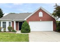 Charming brick home with a manicured lawn and attached two-car garage at 1173 Carlton Ct, Greenwood, IN 46143