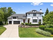 Elegant two-story home featuring a manicured lawn and an attached two car garage at 12208 Island Dr, Indianapolis, IN 46256