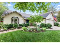 Charming single-story home with well-manicured lawn and lush landscaping at 1482 Waterford Dr, Zionsville, IN 46077