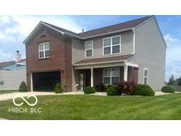 Charming two-story home featuring brick and vinyl siding, a well-manicured lawn, and an attached garage at 2231 Abbey St, Brownsburg, IN 46112