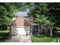 Charming two-story brick home with well-maintained lawn and mature trees at 3474 Glen Abbe Ct, Carmel, IN 46032