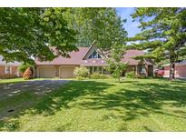 Charming brick home with a well-manicured lawn and mature trees offering shade and curb appeal at 396 W 500 S, Anderson, IN 46013