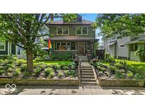 Charming two-story home with a beautifully landscaped front yard and welcoming front porch at 4046 N Park Ave, Indianapolis, IN 46205