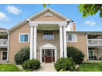 Inviting exterior featuring a well-maintained facade, beautiful landscaping, and covered entrance at 5003 Opal Ridge Ln # 101, Indianapolis, IN 46237