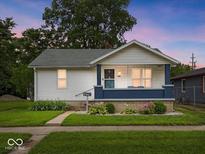 Charming single-story home with white siding, blue porch, and well-maintained lawn at 528 W Mechanic St, Shelbyville, IN 46176