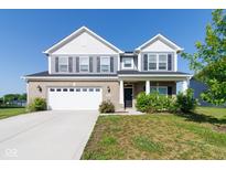 Charming two-story home featuring a brick facade, attached garage, and well-manicured lawn at 6610 Aberdeen Dr, McCordsville, IN 46055
