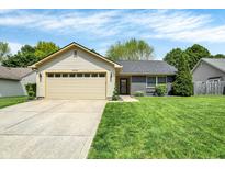 Charming ranch-style home featuring a two-car garage, neutral siding, and a well-maintained front lawn at 6838 Cherry Laurel Ln, Fishers, IN 46038