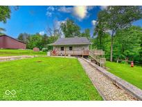 Charming single-story home featuring a quaint porch and well-manicured front lawn at 8635 S Providence Dr, Nineveh, IN 46164