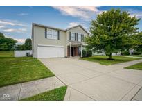 Inviting two-story home with a well-manicured lawn and an attached two-car garage at 9775 Big Bend Dr, Indianapolis, IN 46234