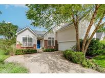 Charming two-story home with brick accents, light siding, blue door, and well-manicured landscaping at 11074 Galley Way, Fishers, IN 46040