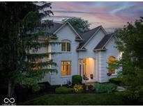 Charming white two-story home with manicured landscaping and inviting front porch at 12450 Petalon Trce, Fishers, IN 46037