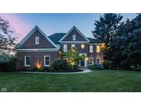 Charming two-story brick home with a well-manicured lawn, landscaping, and inviting front entrance at 15920 Oak Park Ct, Westfield, IN 46074