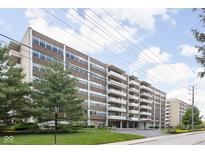Spacious brick apartment building with balconies, well-maintained lawn, and mature trees at 25 E 40Th St # Apt 1B/D, Indianapolis, IN 46205