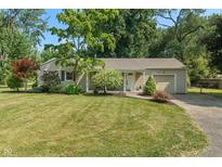 Charming single-story home with a well-maintained lawn and mature trees at 2906 E 65Th St, Indianapolis, IN 46220