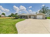 Charming ranch-style home with a large yard, brick exterior, and attached two-car garage at 4511 W 300 S, Anderson, IN 46011
