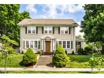 Charming two-story home with a well-maintained lawn and front porch leading to the front door at 4904 N Washington Blvd, Indianapolis, IN 46205