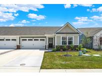 Inviting single-story home featuring an attached two-car garage and meticulously maintained front yard landscaping at 843 Garrow Dr, Westfield, IN 46074