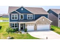 Beautiful two-story home showcasing a blue facade, brick accents, a well-manicured lawn, and a two-car garage at 9053 Fitzgerald Dr, Indianapolis, IN 46239