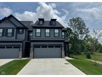 Charming two-story home with a well-manicured lawn and a spacious two-car garage, creating an inviting curb appeal at 9751 Behner Dr, Fishers, IN 46250