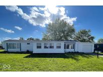 Charming single-story home featuring a well-maintained lawn and an attached garage at 10 Lincoln Cir, Elwood, IN 46036