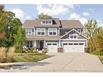Beautiful two-story home featuring a three-car garage, dormer, manicured lawn, and inviting curb appeal at 10262 Rieslaner Cir, Zionsville, IN 46077