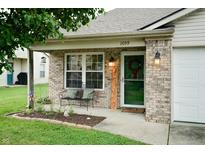 Welcoming front of this home with an inviting bench, a welcome sign, and charming lanterns at 1059 Wild Ivy Trl, Franklin, IN 46131