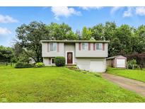 Charming two-story home with a well-maintained lawn and landscaping in a quiet neighborhood at 1103 Rosengarten Dr, Greenwood, IN 46142