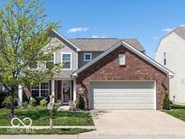 Charming two-story home featuring a brick front, two-car garage, and well-manicured lawn at 12584 Cold Stream Rd, Noblesville, IN 46060