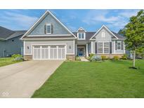 Charming two-story home with a well-manicured lawn and a two-car garage at 12634 Mustard Seed Ct, Fishers, IN 46038