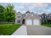 Charming two-story home with a grey brick facade and a well-manicured lawn at 1336 Danielle Rd, Lebanon, IN 46052